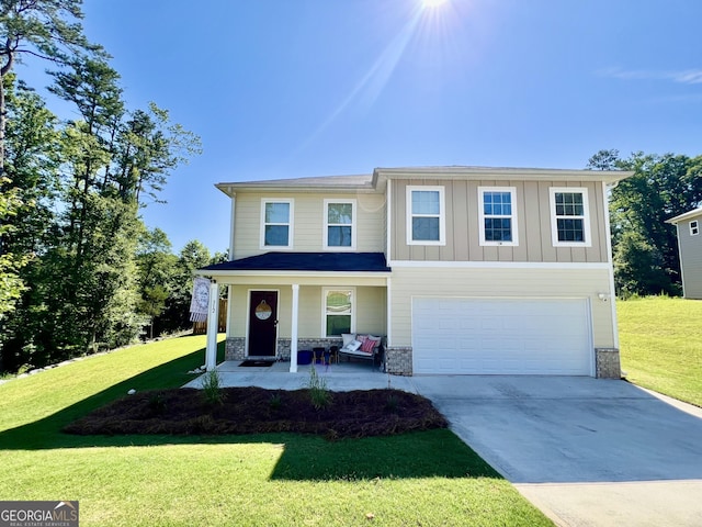 312 Indian River Dr, Jefferson, GA 30549 - view of front of home with covered porch, driveway, an attached garage, and a front yard
