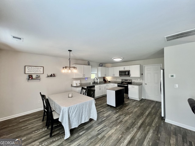 312 Indian River Dr, Jefferson, GA 30549 - dining area with dark wood-type flooring and a chandelier