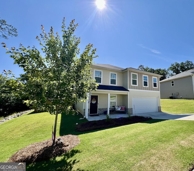 312 Indian River Dr, Jefferson, GA 30549 - view of front of house with driveway, covered porch, a garage, and a front lawn