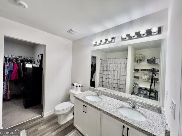 312 Indian River Dr, Jefferson, GA 30549 - full bathroom with wood finished floors, double vanity, a walk in closet, and a shower with curtain