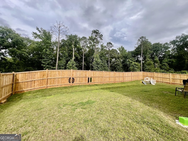 312 Indian River Dr, Jefferson, GA 30549 - fenced backyard with view of wooded area