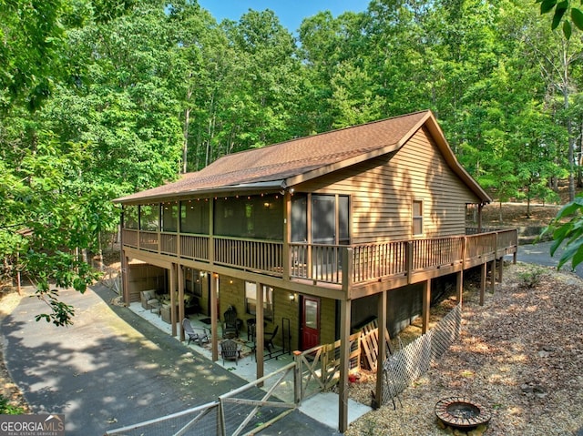 191 Deer Run Rd, Blairsville, GA 30512 - view of front facade featuring a fire pit, a patio area, a deck, and a wooded view