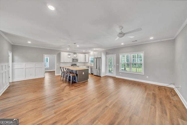 605 Live Oak Way, Dublin, GA 31021 - living room featuring healthy amount of natural light, ornamental molding, recessed lighting, ceiling fan, and light wood finished floors