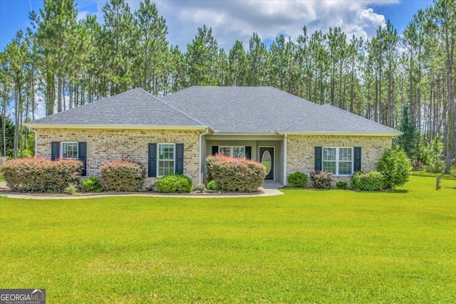 605 Live Oak Way, Dublin, GA 31021 - ranch-style house featuring a front yard, roof with shingles, and brick siding