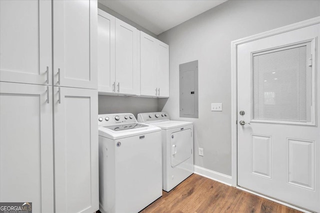 605 Live Oak Way, Dublin, GA 31021 - laundry area with electric panel, washer and dryer, cabinet space, and wood finished floors
