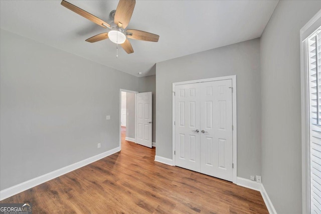 605 Live Oak Way, Dublin, GA 31021 - unfurnished bedroom featuring wood finished floors, a closet, and ceiling fan