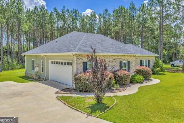 605 Live Oak Way, Dublin, GA 31021 - view of property exterior with a shingled roof, a garage, driveway, and a yard