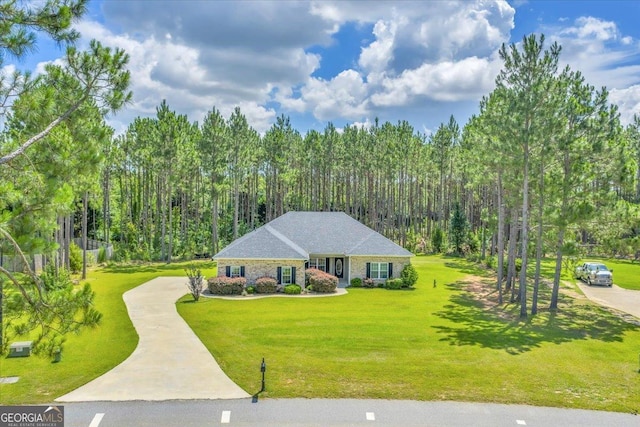 605 Live Oak Way, Dublin, GA 31021 - view of front of house featuring concrete driveway, a front lawn, and a view of trees