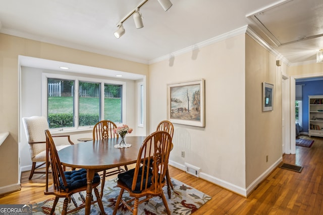 747 Channing Dr NW, Atlanta, GA 30318 - dining area with attic access, track lighting, wood finished floors, and ornamental molding