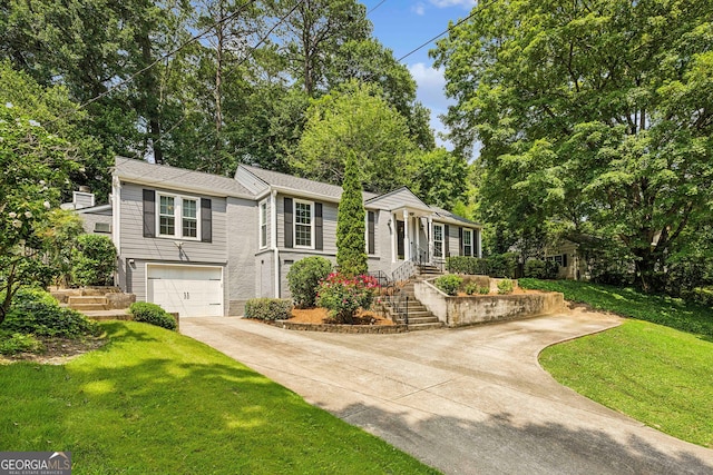 747 Channing Dr NW, Atlanta, GA 30318 - view of front facade featuring driveway, a front lawn, an attached garage, and view of wooded area