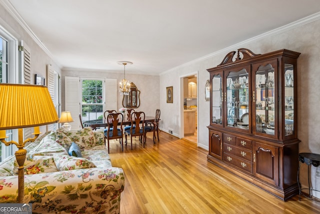 747 Channing Dr NW, Atlanta, GA 30318 - living area featuring light wood-type flooring, a chandelier, and crown molding