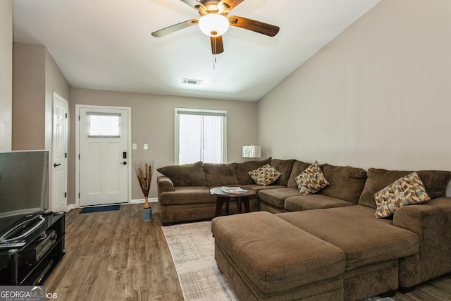 2069 Countydown Ln, Stone Mountain, GA 30088 - living room featuring wood finished floors, ceiling fan, and lofted ceiling
