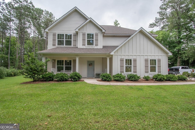 5028 Hammett Rd, Hogansville, GA 30230 - view of front of house with board and batten siding, roof with shingles, a front lawn, and covered porch