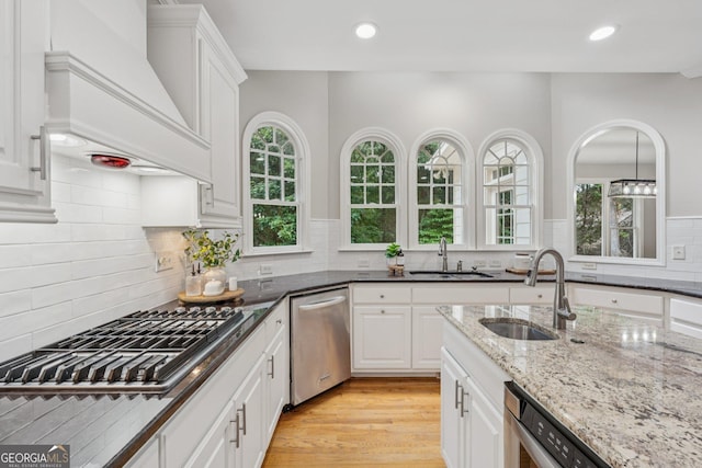 665 Greenview Ter, Milton, GA 30004 - kitchen featuring appliances with stainless steel finishes, premium range hood, white cabinets, light stone counters, and recessed lighting