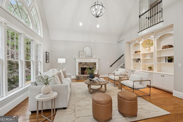 665 Greenview Ter, Milton, GA 30004 - living area with high vaulted ceiling, healthy amount of natural light, stairs, light wood-type flooring, and a fireplace