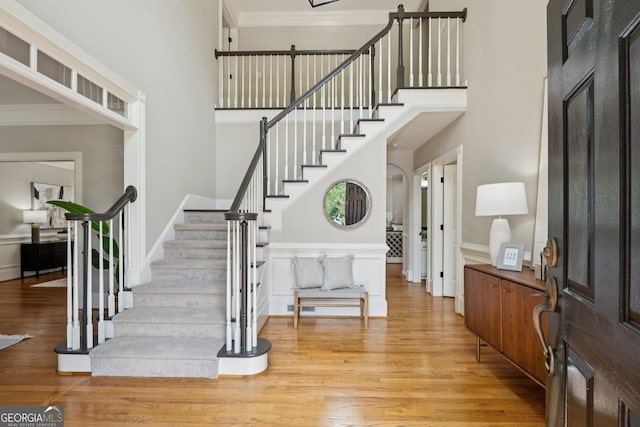 665 Greenview Ter, Milton, GA 30004 - entrance foyer featuring stairway, wood finished floors, a towering ceiling, and crown molding