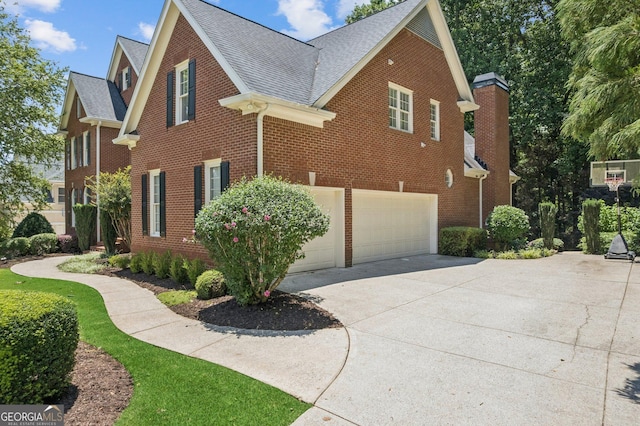 665 Greenview Ter, Milton, GA 30004 - view of side of home with driveway, brick siding, an attached garage, and a shingled roof