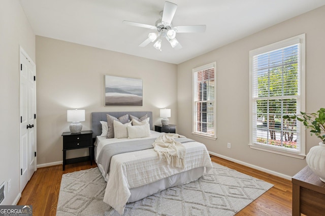 665 Greenview Ter, Milton, GA 30004 - bedroom featuring multiple windows, wood finished floors, and a ceiling fan