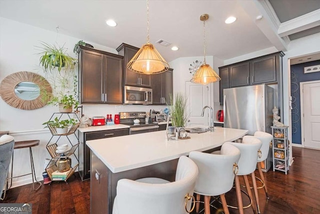 2404 Fitts Dr, Conyers, GA 30094 - kitchen with appliances with stainless steel finishes, dark wood-type flooring, light countertops, dark brown cabinets, and recessed lighting