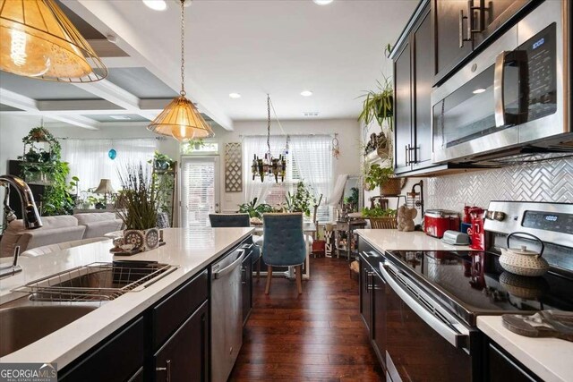 2404 Fitts Dr, Conyers, GA 30094 - kitchen with appliances with stainless steel finishes, decorative backsplash, decorative light fixtures, recessed lighting, and dark wood-style floors