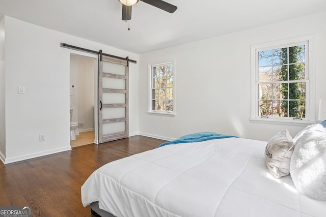 335 Amberidge, Atlanta, GA 30328 - bedroom with a barn door, multiple windows, wood finished floors, and connected bathroom