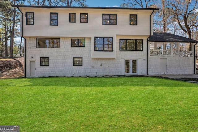 335 Amberidge, Atlanta, GA 30328 - rear view of house with french doors, a lawn, and brick siding