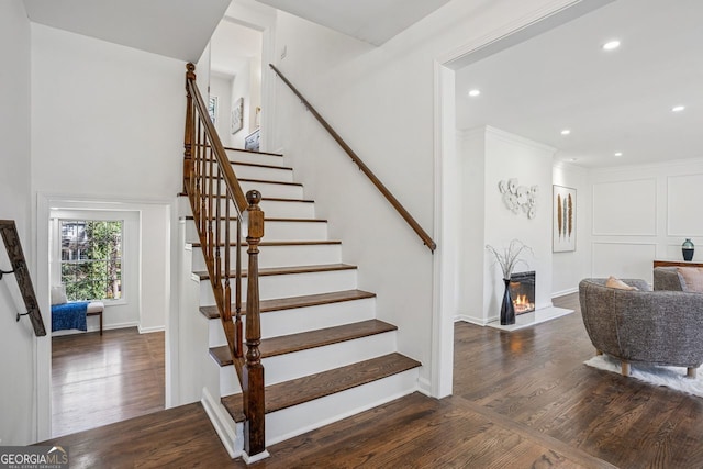 335 Amberidge, Atlanta, GA 30328 - stairway featuring wood finished floors, recessed lighting, and a warm lit fireplace