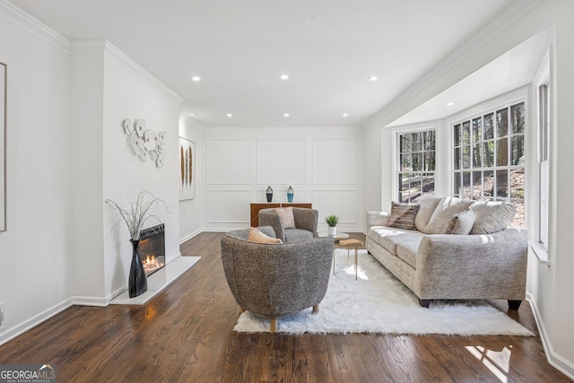 335 Amberidge, Atlanta, GA 30328 - living room with a decorative wall, crown molding, a glass covered fireplace, wood finished floors, and recessed lighting