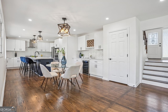 335 Amberidge, Atlanta, GA 30328 - dining space featuring wine cooler, a bar, dark wood-style floors, recessed lighting, and stairway