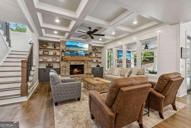 6326 Point Twenty Two, Gainesville, GA 30506 - living room featuring ceiling fan, wood finished floors, stairs, a fireplace, and coffered ceiling
