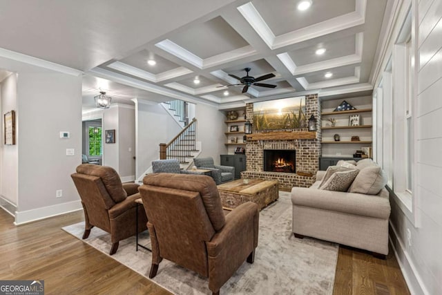 6326 Point Twenty Two, Gainesville, GA 30506 - living room featuring a fireplace, wood finished floors, a ceiling fan, stairway, and ornamental molding