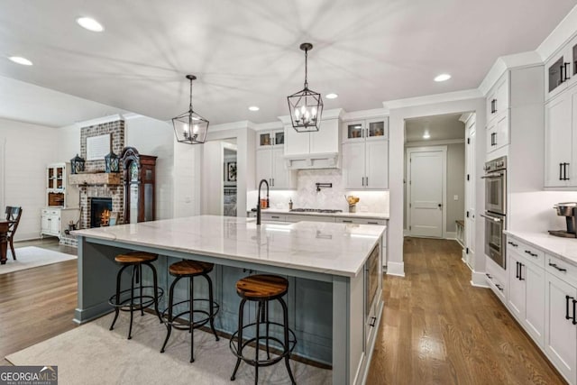 6326 Point Twenty Two, Gainesville, GA 30506 - kitchen featuring a brick fireplace, stainless steel appliances, recessed lighting, dark wood-type flooring, and decorative backsplash