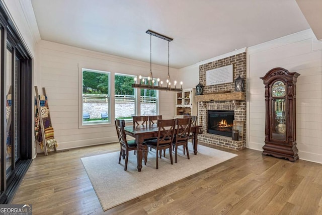 6326 Point Twenty Two, Gainesville, GA 30506 - dining space with a chandelier, wood finished floors, and a fireplace
