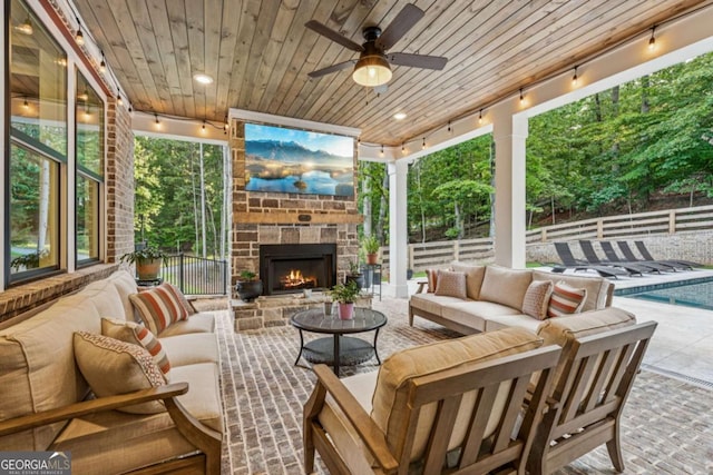 6326 Point Twenty Two, Gainesville, GA 30506 - fenced backyard with an outdoor living space with a fireplace, a patio area, and a ceiling fan