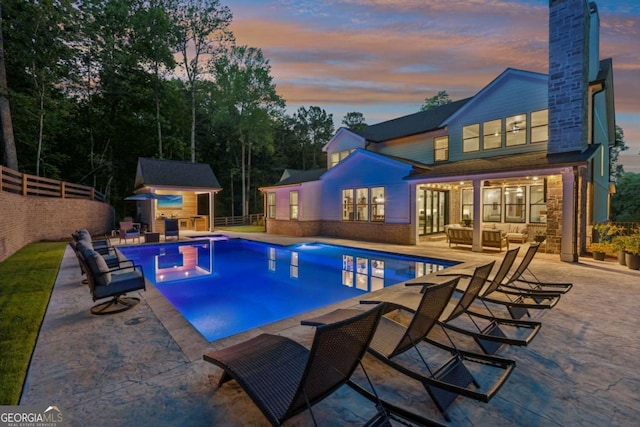 6326 Point Twenty Two, Gainesville, GA 30506 - pool at dusk with an outdoor hangout area, an outdoor structure, and a patio