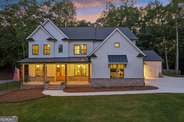 6326 Point Twenty Two, Gainesville, GA 30506 - back of house at dusk featuring a standing seam roof, concrete driveway, covered porch, and board and batten siding