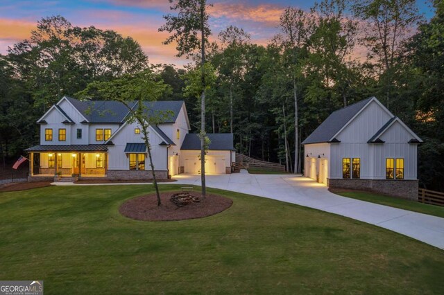 6326 Point Twenty Two, Gainesville, GA 30506 - modern farmhouse style home featuring curved driveway, a standing seam roof, board and batten siding, and covered porch