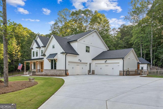 6326 Point Twenty Two, Gainesville, GA 30506 - view of front of house with an attached garage, driveway, roof with shingles, and board and batten siding