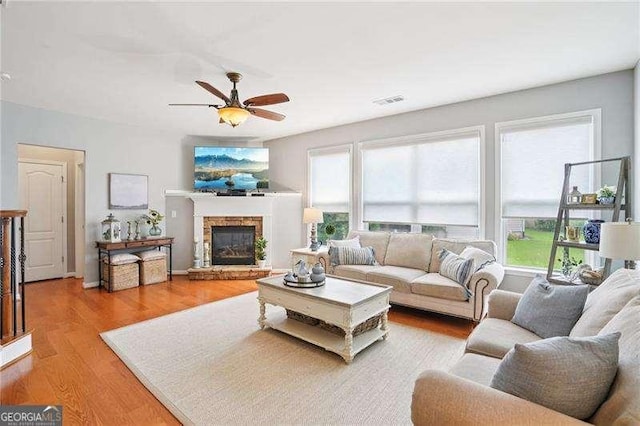 233 Hampton Station Blvd, Canton, GA 30115 - living room featuring ceiling fan, light wood-style floors, and a fireplace