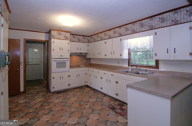 350 Laurel Ln, Lagrange, GA 30241 - kitchen with oven, white cabinets, crown molding, light countertops, and black electric cooktop