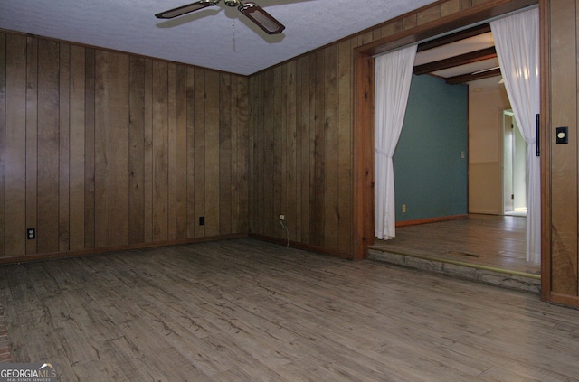 350 Laurel Ln, Lagrange, GA 30241 - unfurnished room featuring a ceiling fan, wood finished floors, and wood walls