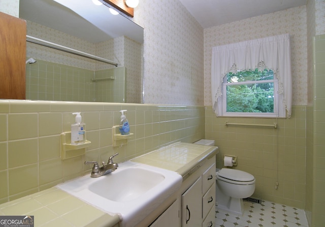 350 Laurel Ln, Lagrange, GA 30241 - full bathroom with wallpapered walls, tile walls, a shower, vanity, and wainscoting