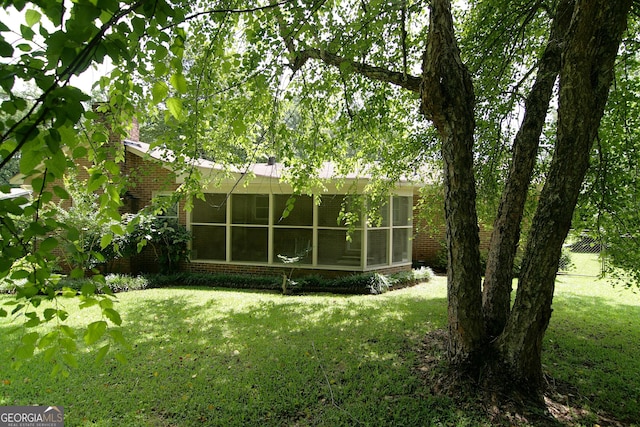 350 Laurel Ln, Lagrange, GA 30241 - back of property featuring brick siding, a sunroom, and a yard