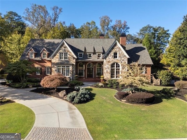4634 Whitestone Way, Suwanee, GA 30024 - view of front of property with stone siding, a chimney, and a front yard