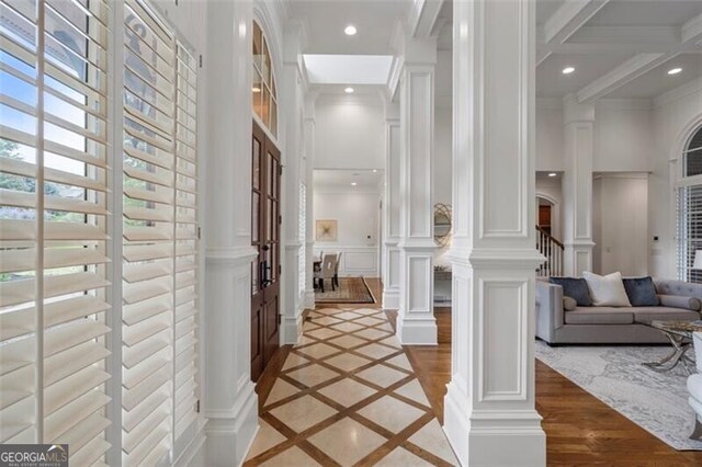 4634 Whitestone Way, Suwanee, GA 30024 - hall featuring inlaid floor details, ornate columns, a decorative wall, recessed lighting, and ornamental molding