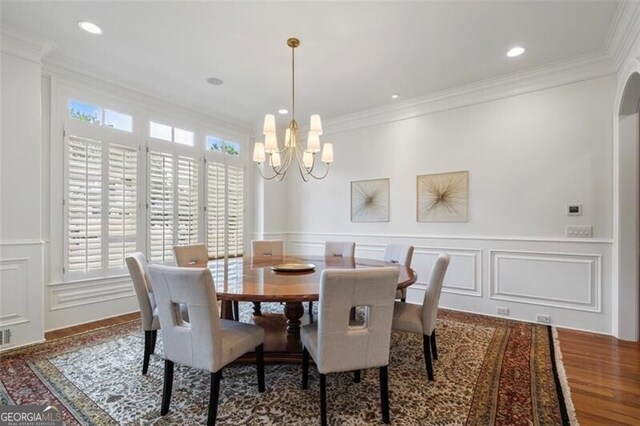 4634 Whitestone Way, Suwanee, GA 30024 - dining room featuring a decorative wall, a chandelier, crown molding, and wainscoting