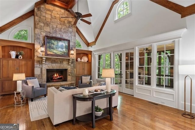 4634 Whitestone Way, Suwanee, GA 30024 - living area featuring a ceiling fan, high vaulted ceiling, a fireplace, beamed ceiling, and healthy amount of natural light