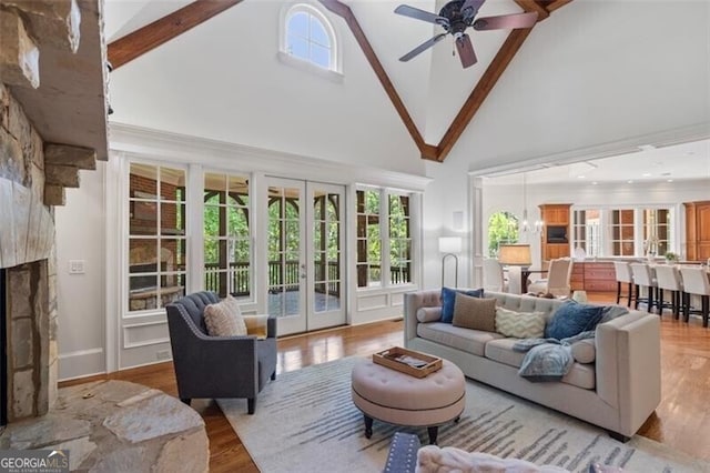 4634 Whitestone Way, Suwanee, GA 30024 - living area with high vaulted ceiling, french doors, ceiling fan, wood finished floors, and beam ceiling