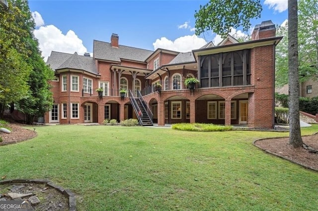 4634 Whitestone Way, Suwanee, GA 30024 - rear view of property featuring a chimney, a yard, stairway, and brick siding