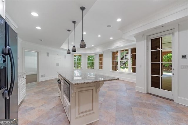 4634 Whitestone Way, Suwanee, GA 30024 - kitchen with black fridge with ice dispenser, ornamental molding, stainless steel microwave, light stone counters, and hanging light fixtures